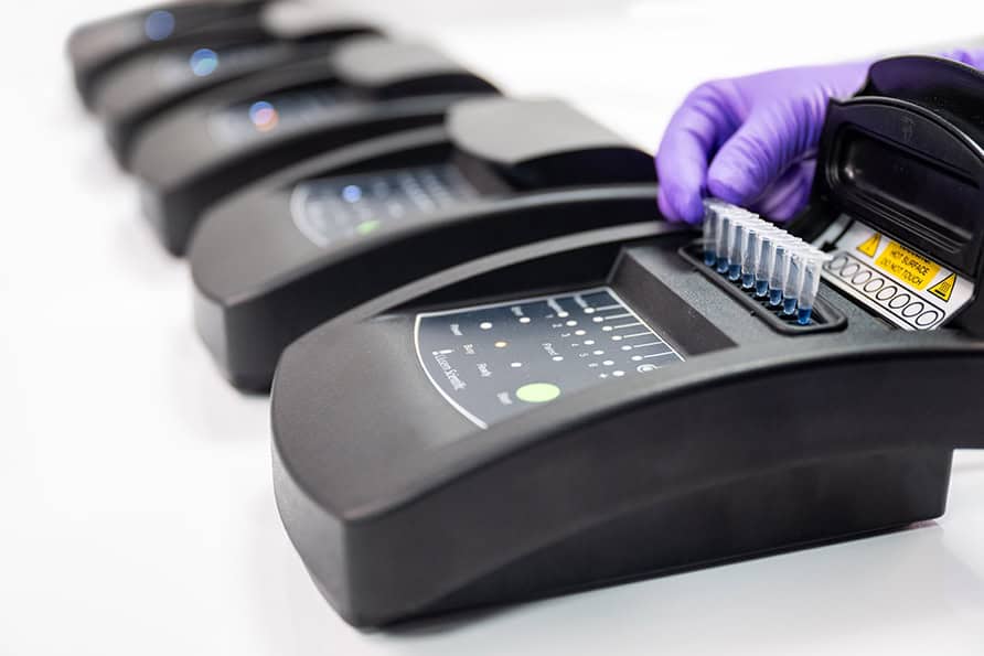 row of machines with vials in